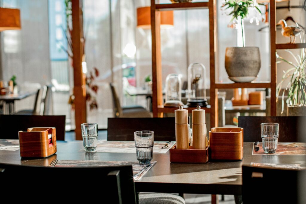Casual restaurant interior with sunlit tables and modern decor, perfect for dining.