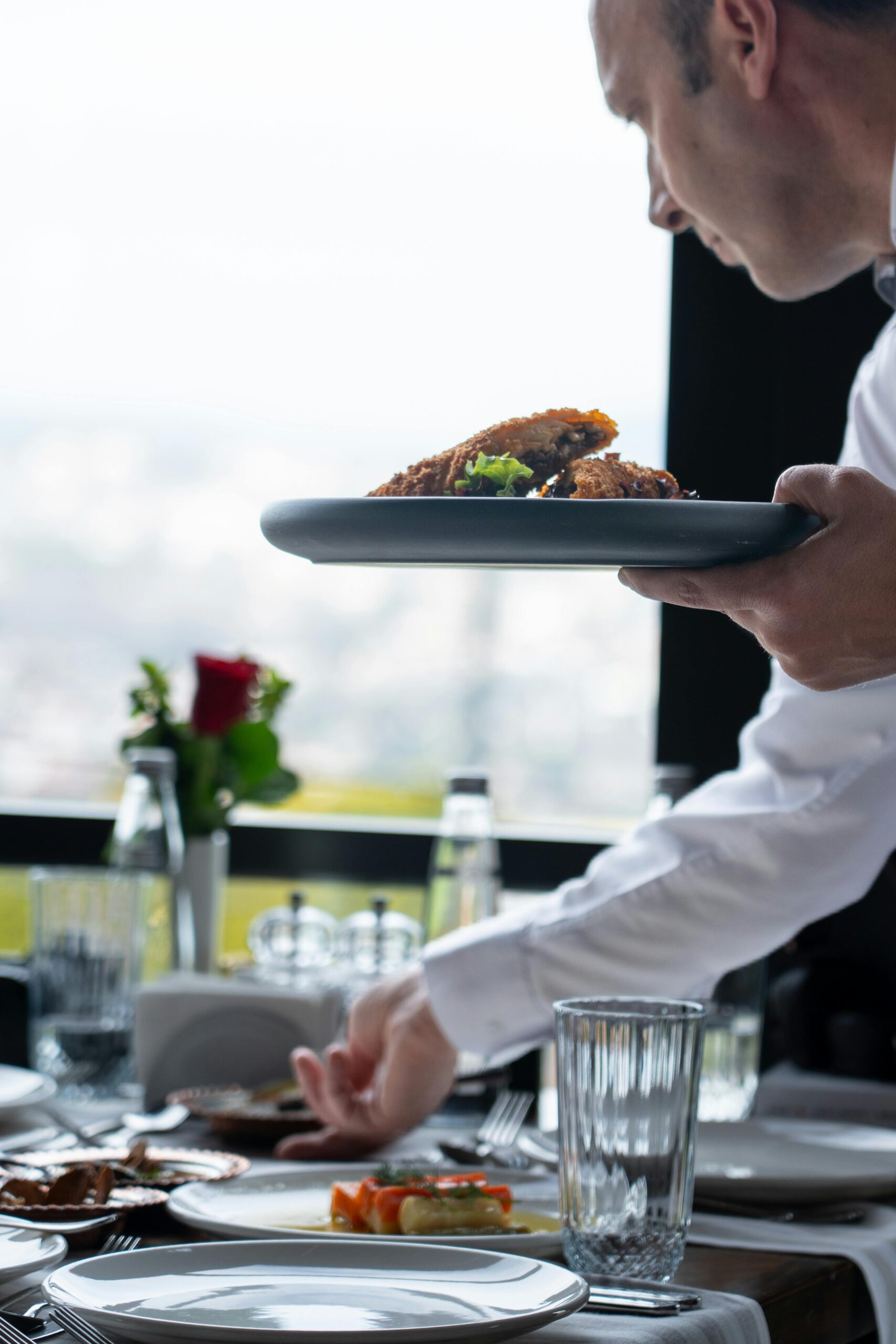 Waiter serving a plate of food