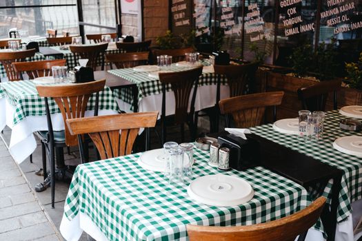 Outdoor restaurant tables with checkered tablecloths